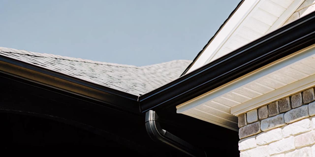 Well-maintained gutter system directing rainwater away from a Texas home