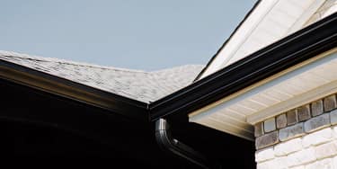 Well-maintained gutter system directing rainwater away from a Texas home
