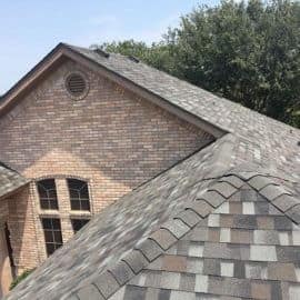 Newly built residential roof on a Texas home under a clear blue sky